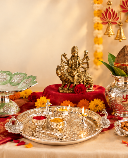 Traditional Navratri Pooja Gifts Online in India Navratri puja gift collection with a goddess idol, silver thali, kalash, diyas, flowers, and dry fruits